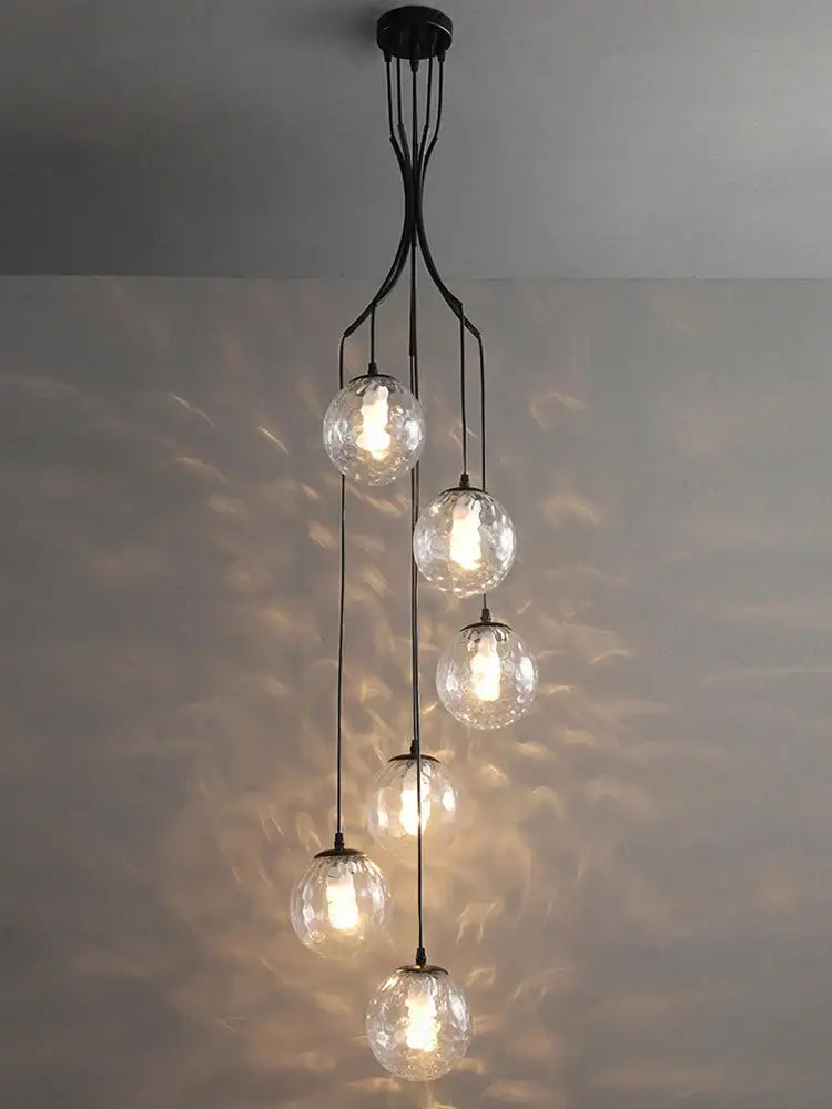 Elegant black metal decorbites glass ball chandelier with five clear textured globes cascading for staircase lighting
