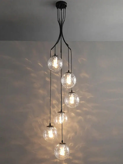 Elegant black metal decorbites glass ball chandelier with five clear textured globes cascading for staircase lighting