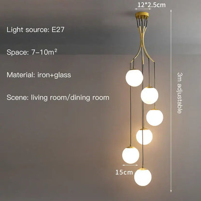 Gold-toned iron decorbites glass ball chandelier with five spherical globe lights for modern minimalist staircase decor