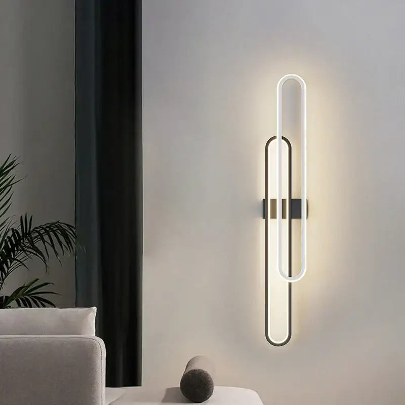 Modern minimalist decorbites led wall sconce with elongated oval design and warm white light for bedroom use