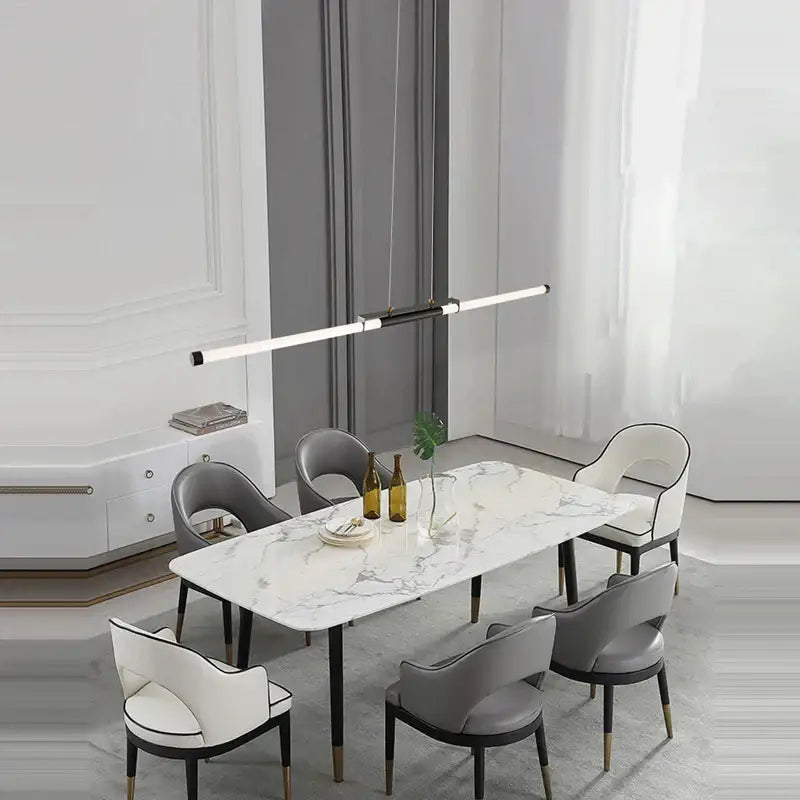Modern marble dining table with sleek black legs paired with decorbites dimmable led acryl minimalist chandelier