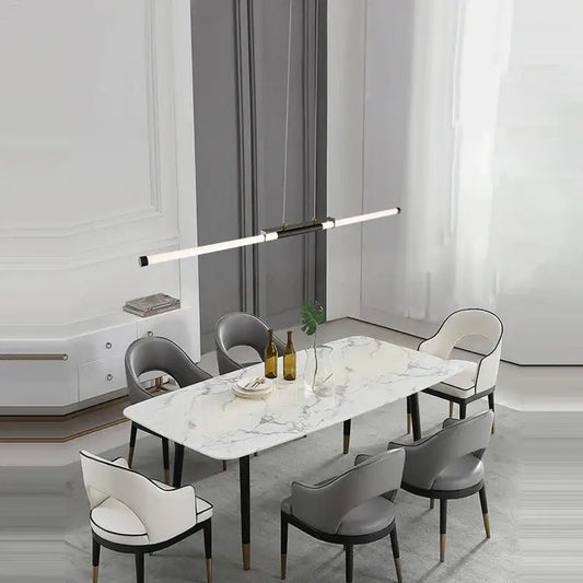 Modern marble dining table with sleek black legs paired with decorbites dimmable led acryl minimalist chandelier