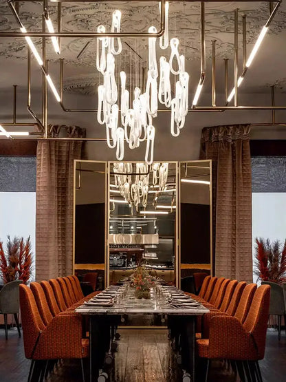 A modern minimalist elegant led glass chandelier with translucent teardrop glass elements for dining room lighting