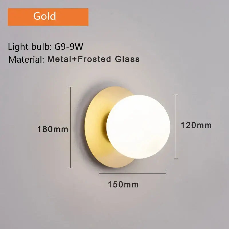 Gold-toned modern minimalist led wall lamp with circular frosted glass diffuser and metal base for bedroom sconce lighting