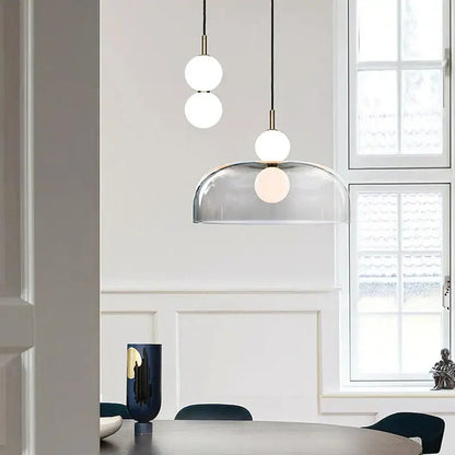 Modern minimalist pendant light featuring frosted glass ball spheres and a transparent dome shade for living room decorbites glass ball