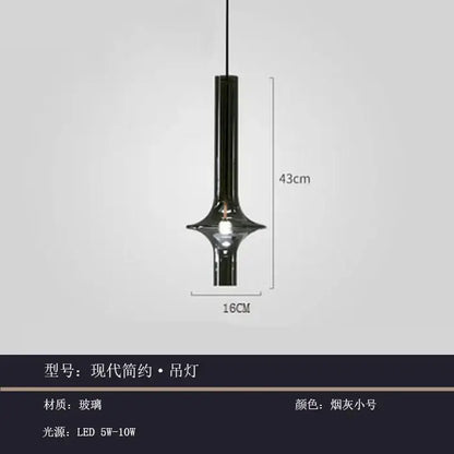 A sleek modern glass pendant light with smoked glass finish and minimalist cylindrical design for kitchen use