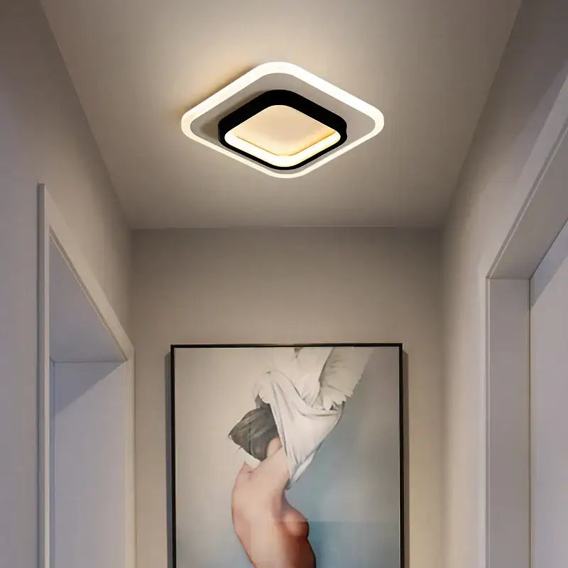 Modern minimalist gold led ceiling light featuring a black center and white illuminated frame for stylish living room decorbites led ceiling