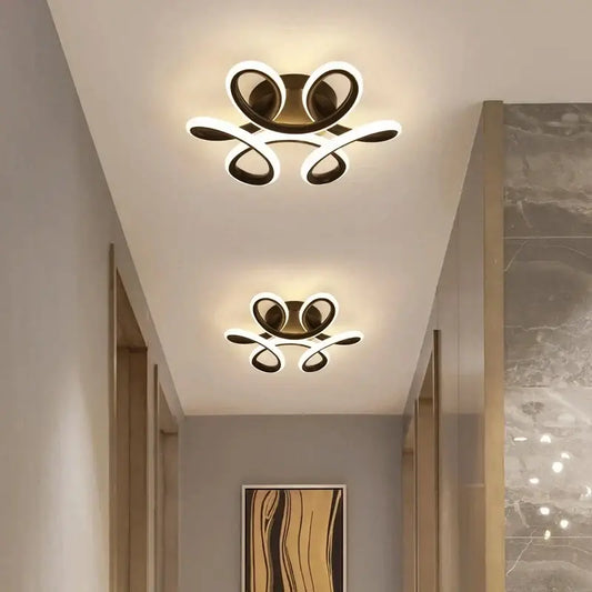 Modern minimalist gold led ceiling light with sleek curved arms and glowing white illumination for living room decorbites led ceiling