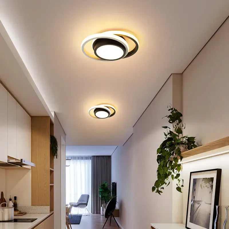 Modern minimalist gold led ceiling light with circular black and white rings emitting warm glow for living room decorbites led ceiling