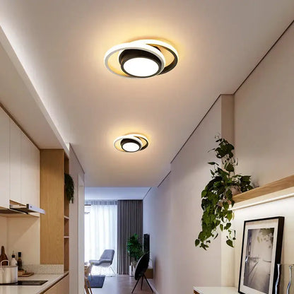 Modern minimalist gold led ceiling light with circular black and white rings emitting warm glow for living room decorbites led ceiling