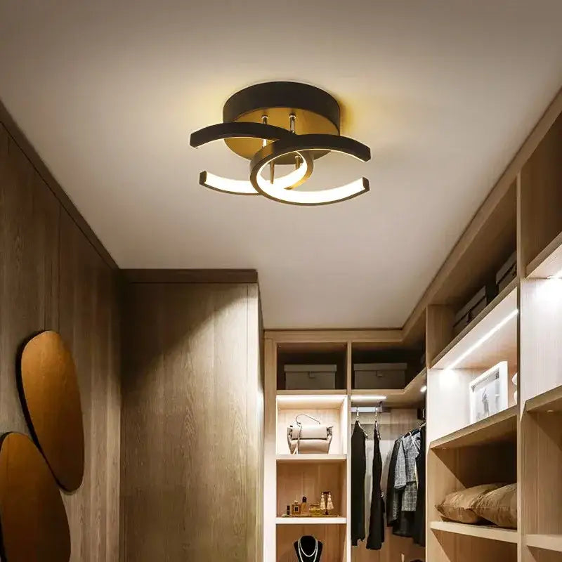 Modern minimalist black and gold decorbites led ceiling light with curved arms and sleek circular led rings for living room decor