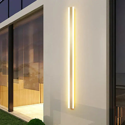 Modern minimalist gold led outdoor wall sconce with two slim vertical led strips emitting warm golden glow decorbites gold led