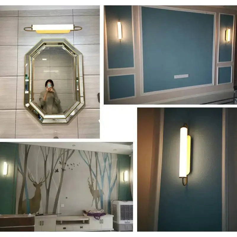 Modern minimalist gold led wall lamp with cylindrical sconce mounted above tiled wall below octagonal mirror