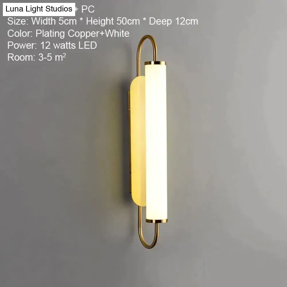 Copper-plated led wall lamp with sleek modern design featuring white diffuser and minimalist curved metal arms for bedroom use
