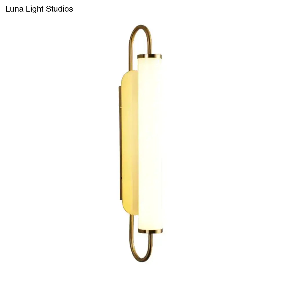 Modern minimalist gold led wall lamp with brass finish and frosted glass diffuser for bedroom cylindrical sconce