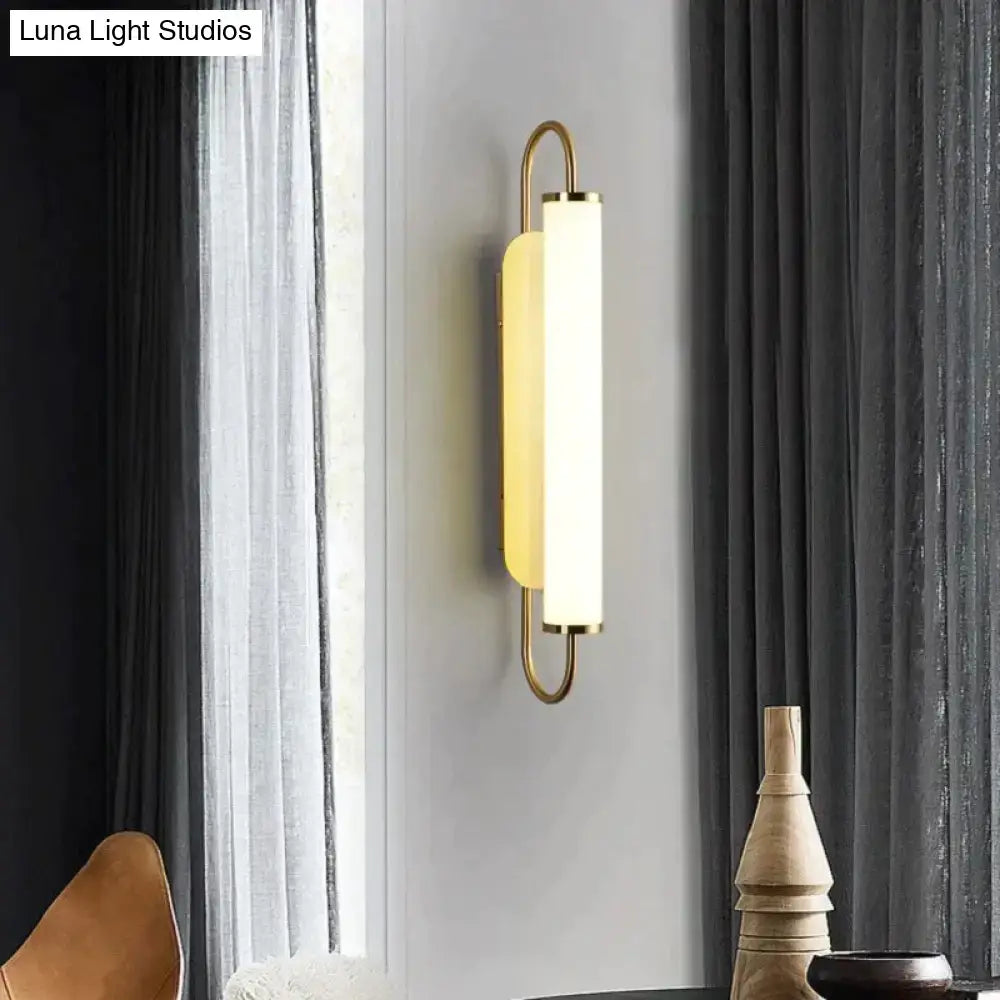 Modern minimalist gold led wall lamp with sleek curved metal frame and frosted glass diffuser for bedroom wall lamp