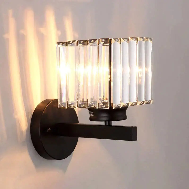Modern minimalist wall lamp with black metal frame and vertical crystal rods for bedroom lighting