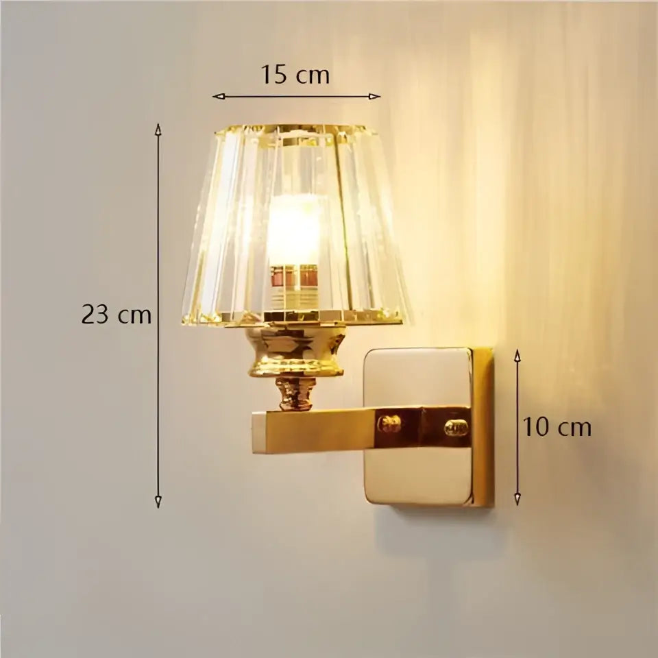 Modern minimalist gold wall lamp with a faceted crystal shade designed for bedroom lighting