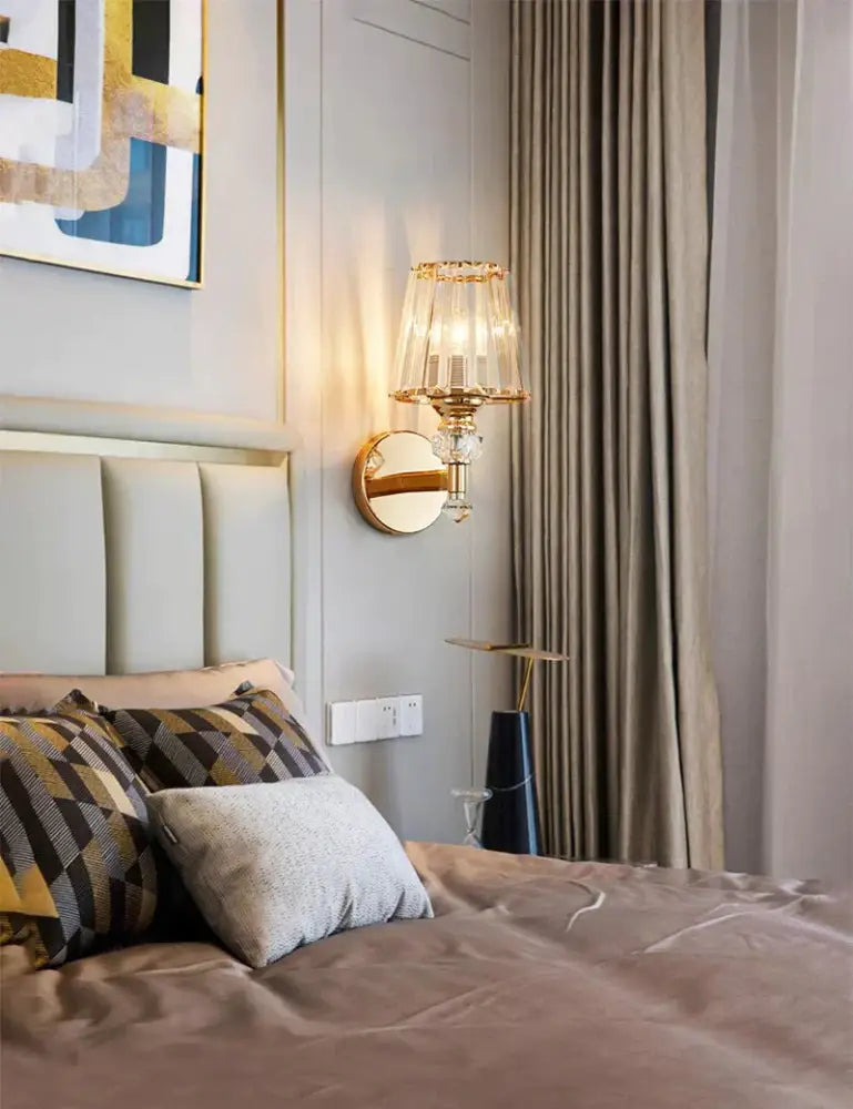 Modern minimalist wall lamp gold toned with crystal encrusted tiered glass shade and mirrored backplate for bedroom