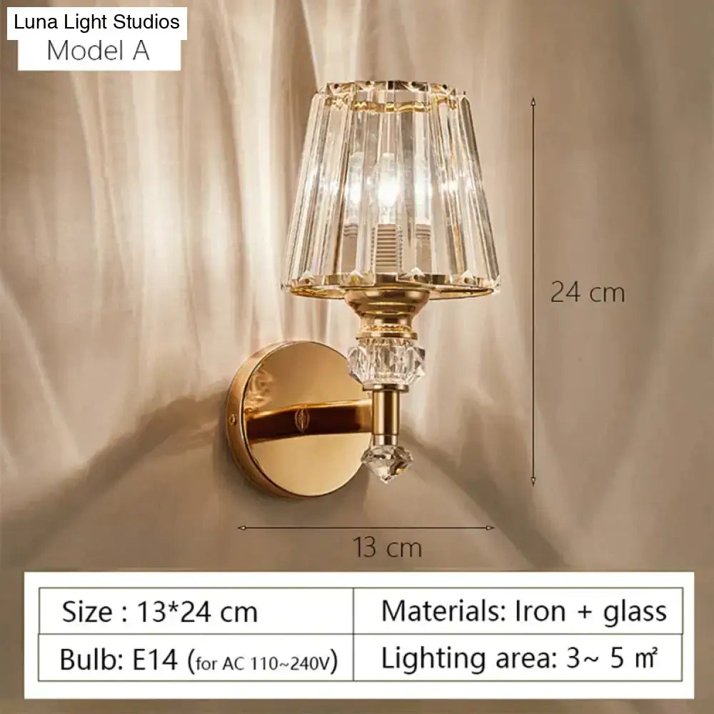 Modern minimalist gold wall lamp with faceted crystal shade and decorative glass elements for bedroom lighting