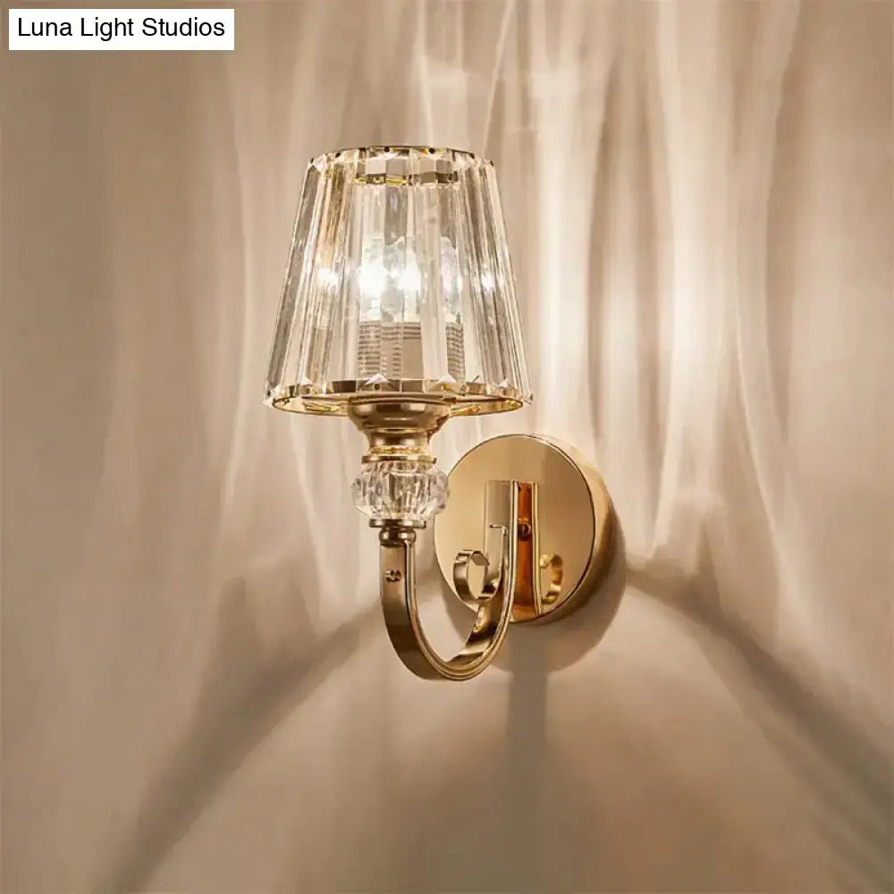 Modern minimalist gold wall lamp featuring a faceted crystal shade and decorative crystal accents for bedroom use