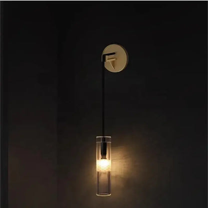 Minimalist wall lamp with sleek circular brass base black cable and transparent glass shade decorbites golden glass wall design