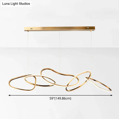 Modern minimalist golden hanging light with interconnected flowing rings suspended from a sleek rectangular bar
