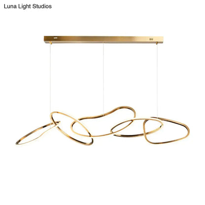 Modern minimalist golden led hanging light with sleek interlocking circular rings suspended from brass fixture for dining room