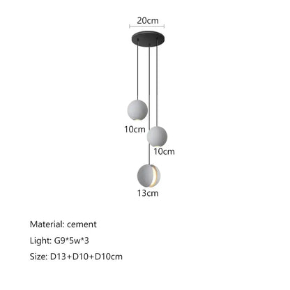 Modern minimalist gray and gold pendant light featuring matte cement spheres and a sleek black mount for dining room decorbites cement planet chandelier