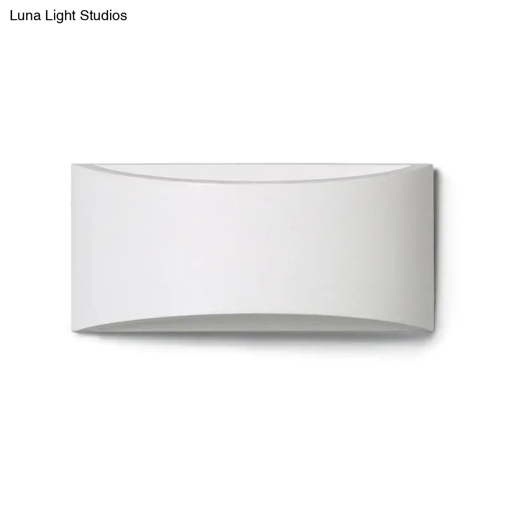 A sleek modern white wall-mounted light fixture with a curved minimalist design for bedroom led lighting