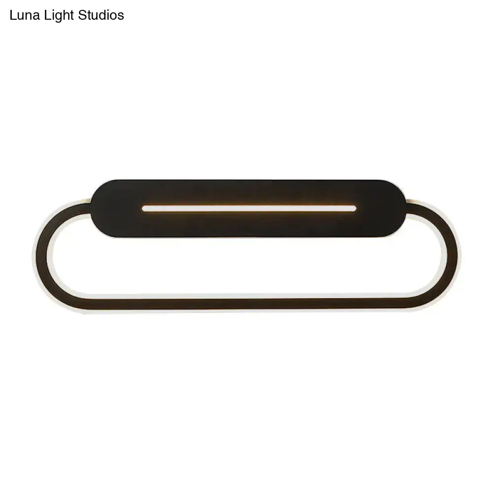 Modern minimalist gray acrylic oval led wall sconce with integrated led strip emitting warm bedroom light