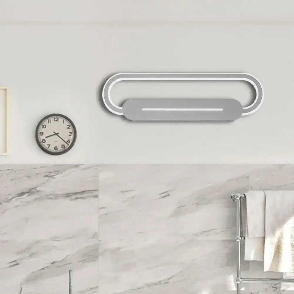 Modern minimalist gray acrylic oval led wall sconce with concentric rings and central horizontal led illumination for bedroom