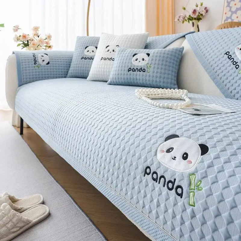 Modern minimalist light green quilted sofa cover with embroidered panda faces and bamboo motifs for living room use