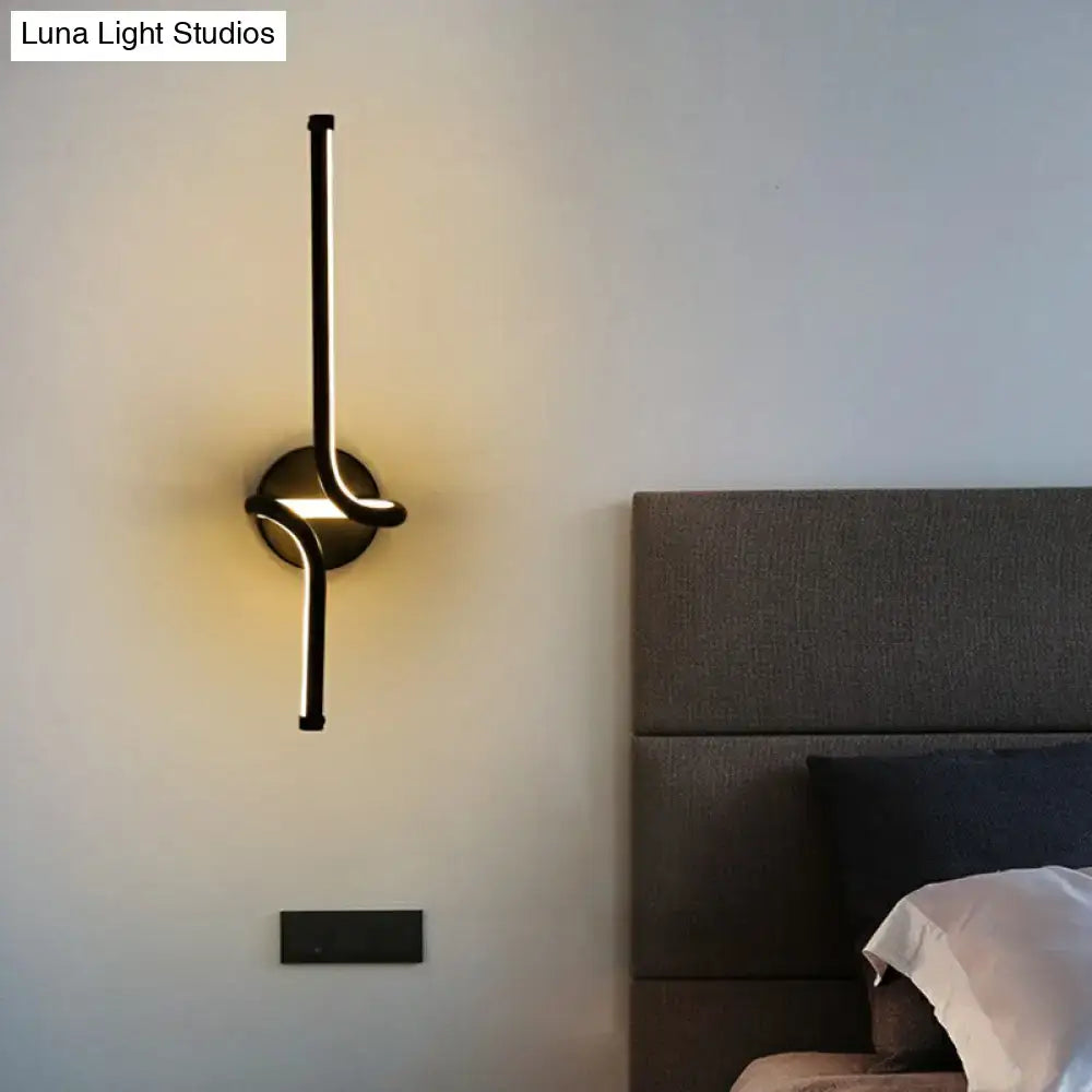 Modern minimalist black metal led wall sconce with sleek linear design and warm ambient lighting for bedroom use
