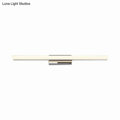 Modern minimalist silver led vanity lamp with polished chrome housing and frosted glass diffuser in a bathroom wall sconce