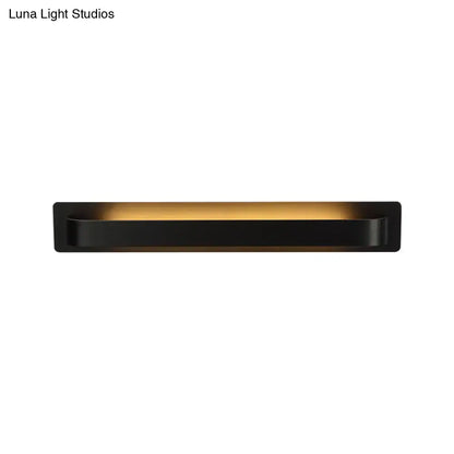 Black rectangular wall lamp with sleek modern design and warm golden illumination for living room lighting