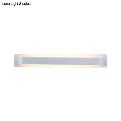 Modern minimalist silver linear wall lamp with a sleek rectangular design and frosted glass diffuser emitting warm light