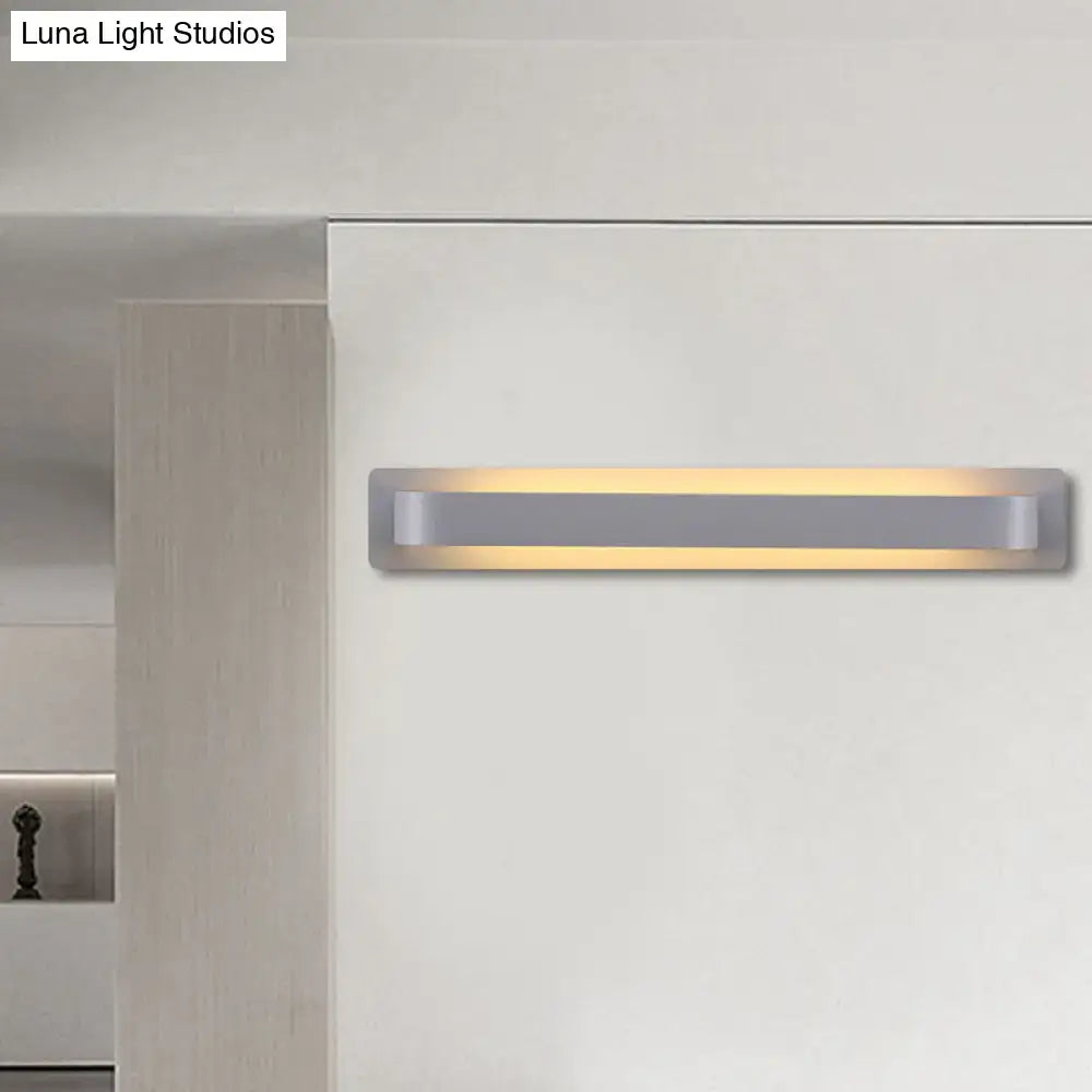 Modern minimalist silver linear wall lamp with sleek metallic finish and warm led illumination for living room