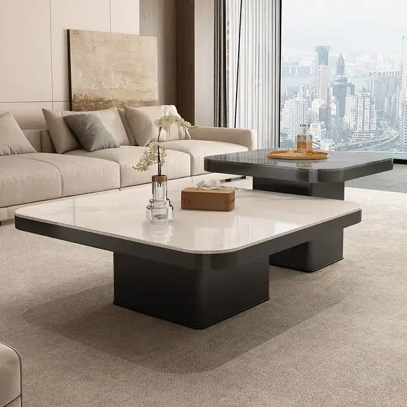 Modern minimalist coffee table set featuring a rectangular glossy white top and sleek black base for living room use