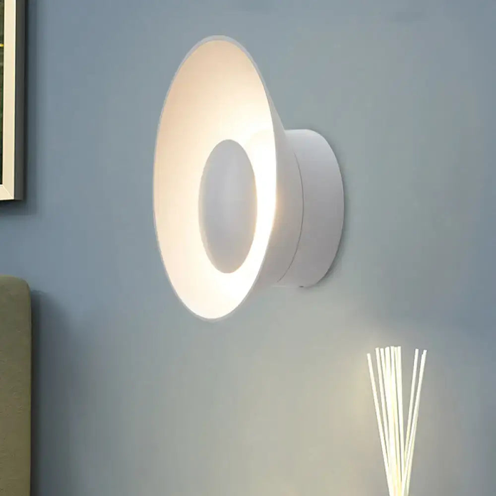 White circular wall lamp with modern minimalist design and soft ambient LED lighting for living room use