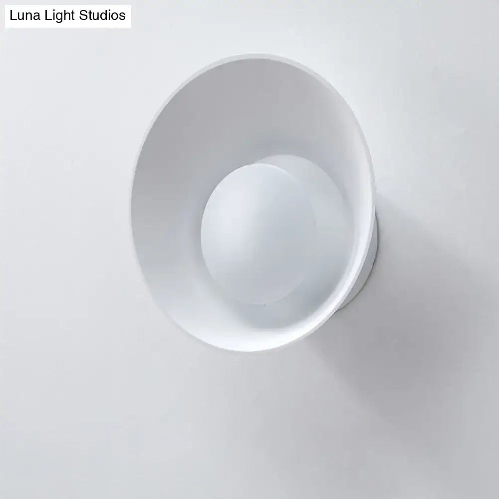 Modern minimalist white wall lamp with matte conical shade and integrated circular led light for living room use