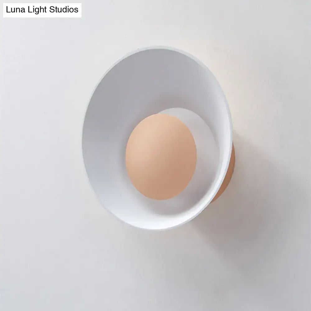 Minimalist white and black led wall lamp with warm circular light source mounted on white wall for living room use
