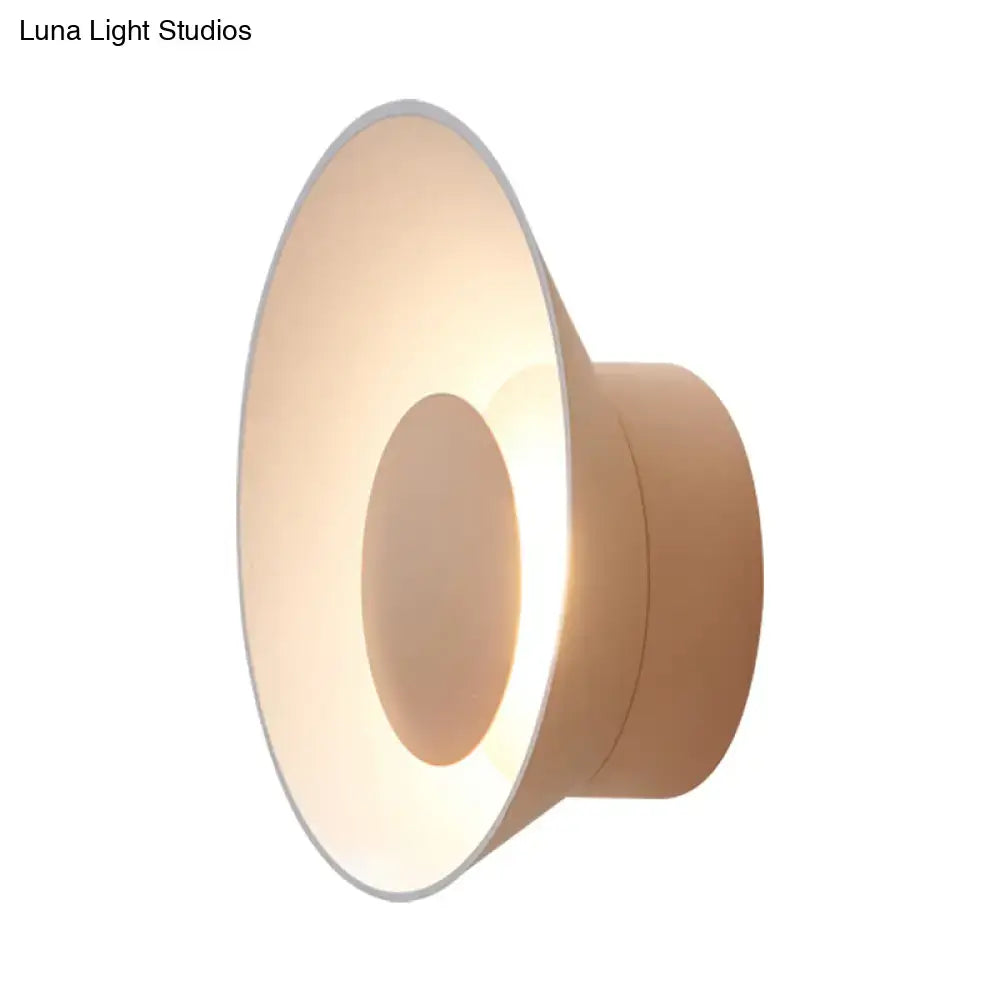 Modern minimalist beige wall lamp with sleek circular design and soft ambient LED lighting for living room use