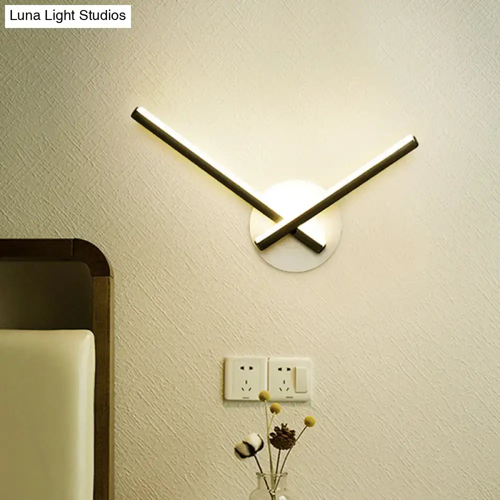 Modern minimalist white ceiling light with direct wired electric installation and black metal bars emitting warm light