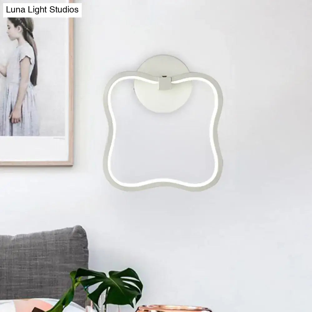 Modern minimalist white curved square led wall sconce with cloud-like silhouette and sleek metallic trim for bedroom lighting