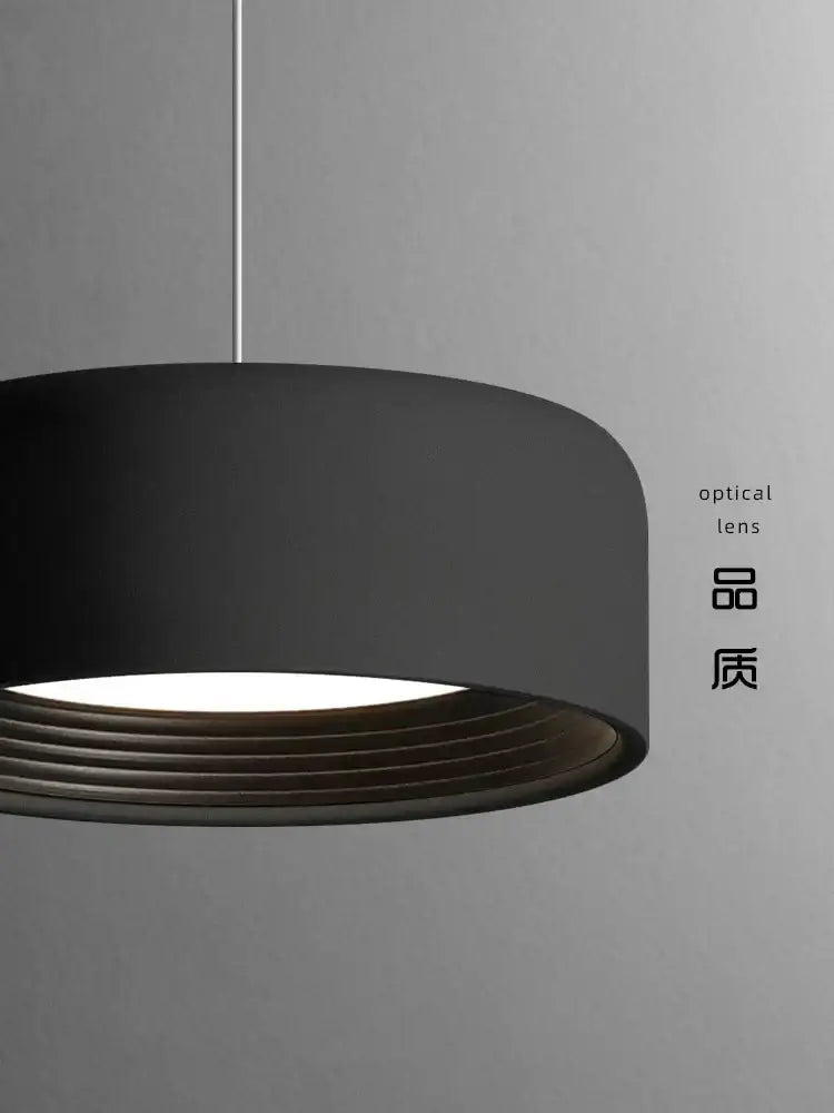 Modern minimalist black cylindrical pendant light with matte finish and concentric ridges from decorbites designer led chandelier collection
