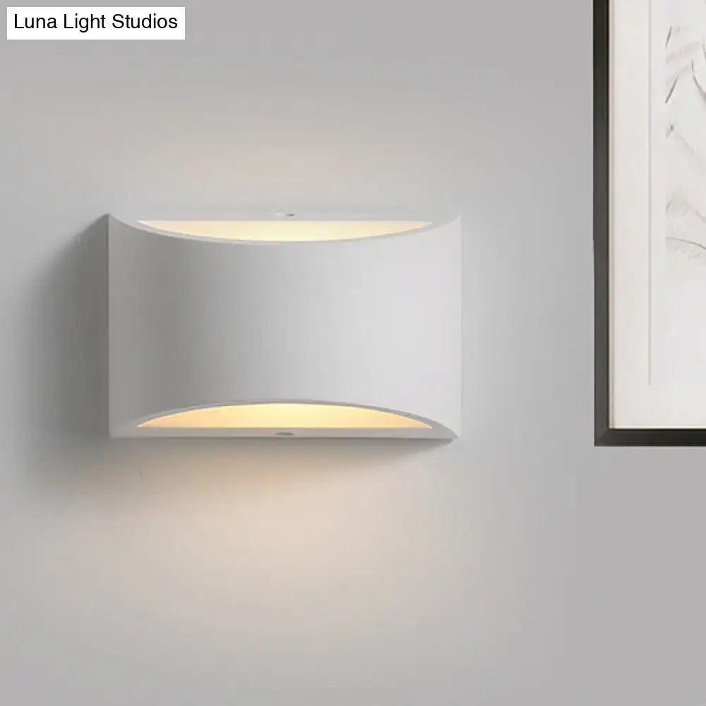 Modern minimalist white gypsum sconce lamp with sleek curved design and warm ambient lighting for bedroom use