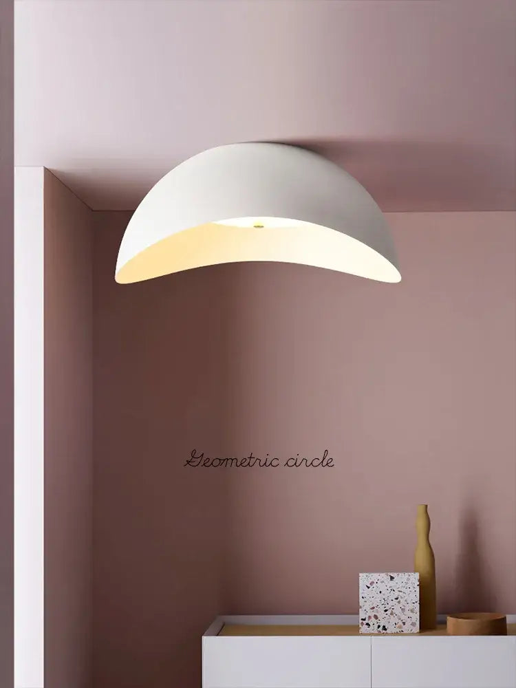 A sleek white semi-spherical decorbites ingot ceiling lamp with matte finish and warm glow for bedroom lighting
