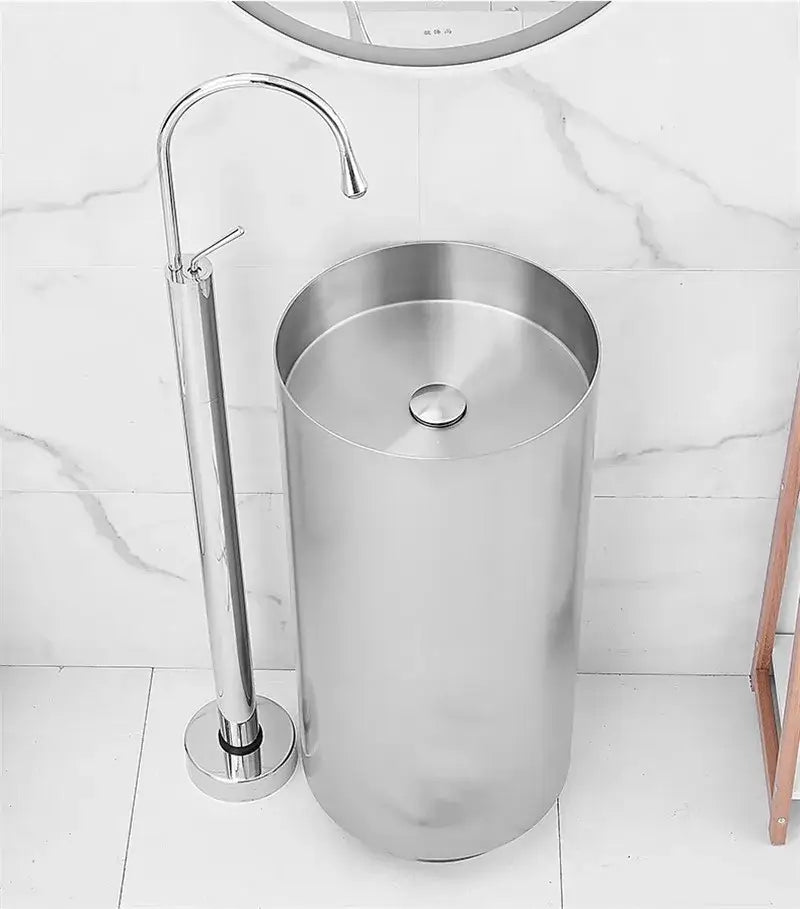 Modern minimalist white freestanding bathroom sink with shiny chrome floor standing bathtub faucet and curved spout