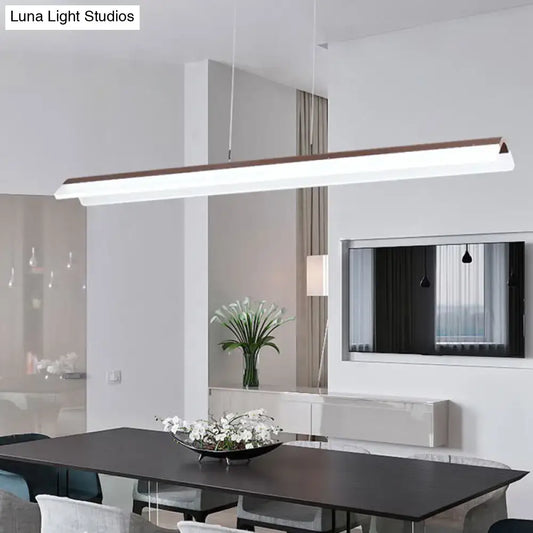 Modern minimalist pendant light fixture with white aluminum body and wood-toned top edge for dining room use